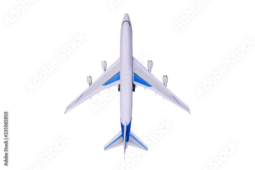 Model airplane on a white background. Toy airplane, top view. Passenger liner for flying around the world. Travel and tourism.