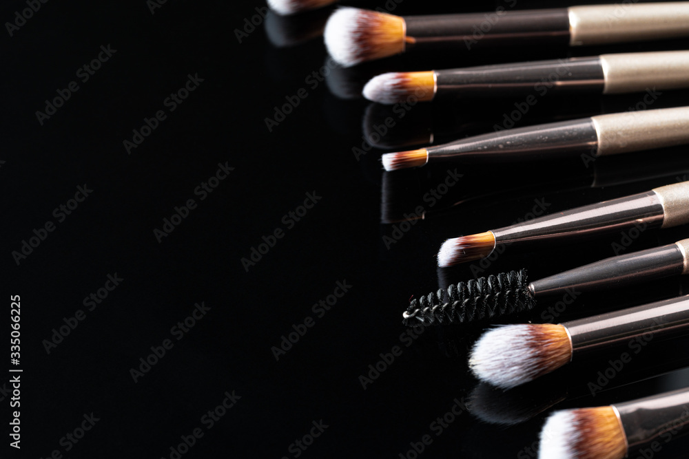 Collection of make up brushes on black background, close up Collection of make up brushes on black background, close up
