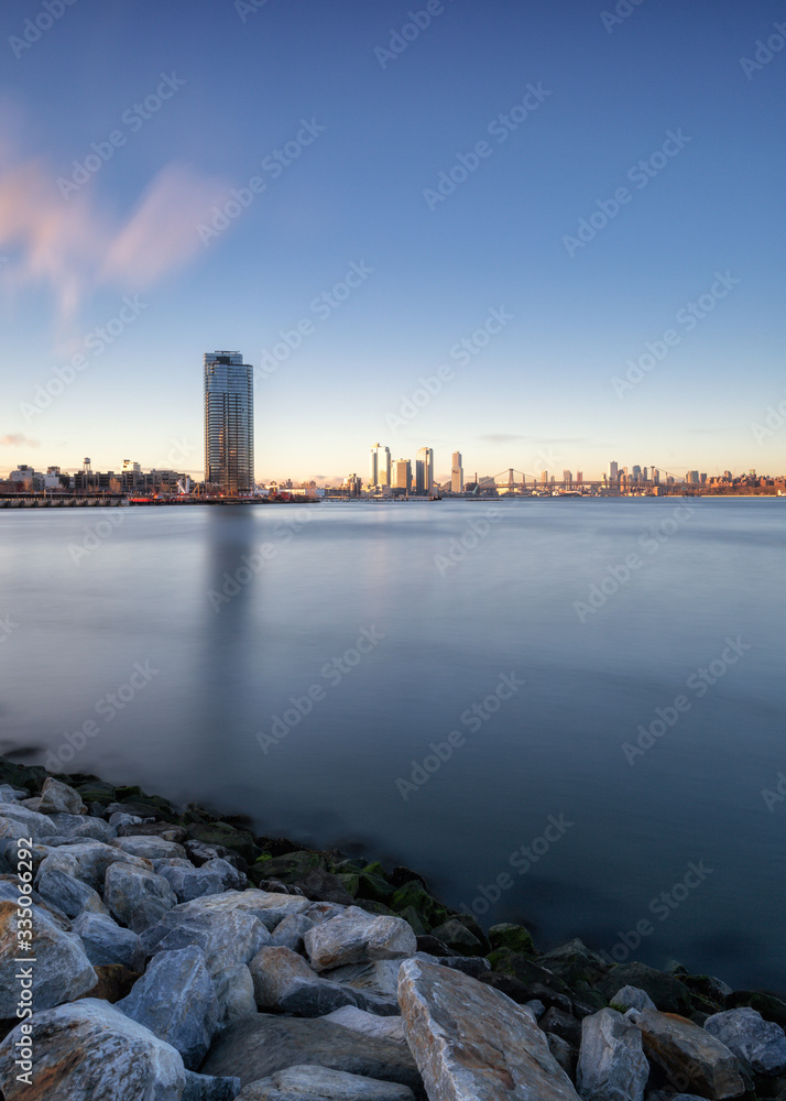 View on Brooklyn and Williamsburg from East River during sunrise with long exposure