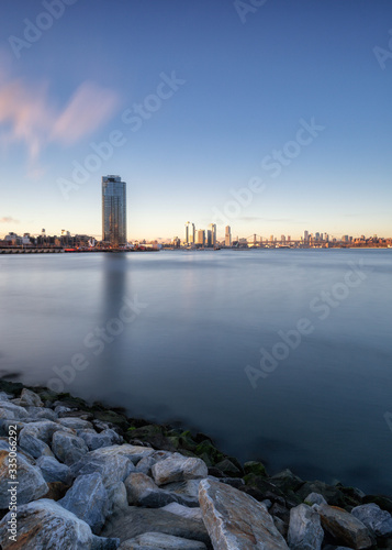 View on Brooklyn and Williamsburg from East River during sunrise with long exposure