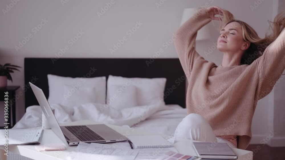 Young woman have break in laptop at home, touches hair, massage head Young woman have break in laptop at home, touches hair, massage head