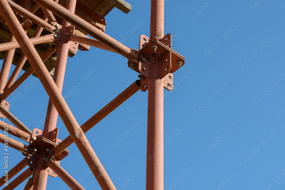 Scaffolding Elements Construction. Metal scaffolding tubes and bars. Construction site details. Bridge support. Industrial background. Scaffolding Elements Construction. Metal scaffolding tubes and bars. Construction site details. Bridge support. Industrial background.