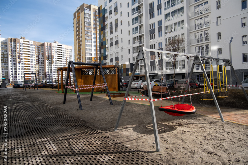 cordoned off swings on a playground in time of coronavirus quarantine - Tyumen, Russia, March 31, 2020 cordoned off swings on a playground in time of coronavirus quarantine - Tyumen, Russia, March 31, 2020