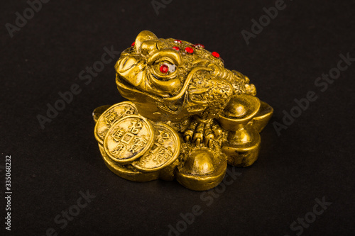 statuette Buddha gold frog. isolated on black background