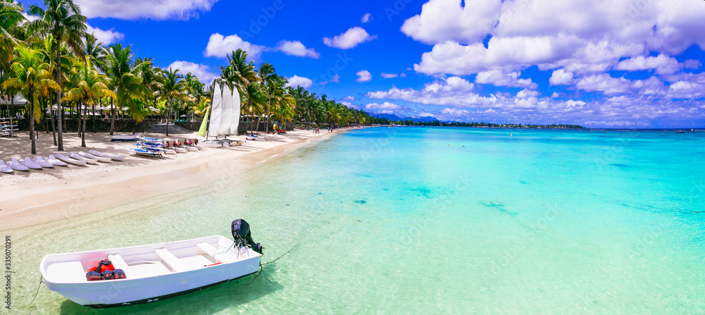 Beach activities in tropical paradise Mauritius island. Trou aux Biches beach