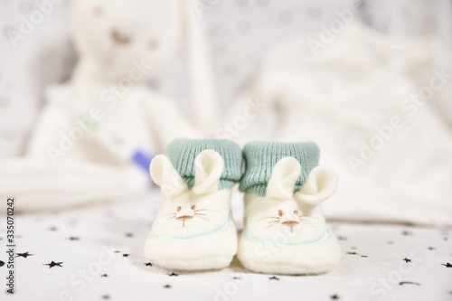 white and green bunny baby booties. concept baby on the way.