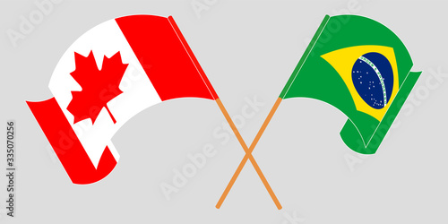Crossed and waving flags of Brazil and Canada