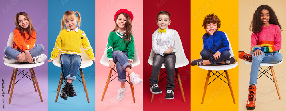 Cheerful kids in stylish clothes sitting on chairs - obrazy, fototapety, plakaty 