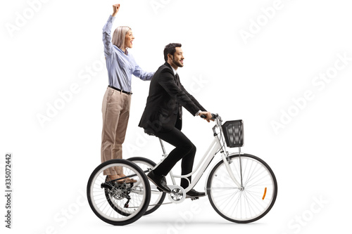 Happy woman riding on tricycle with a businessman