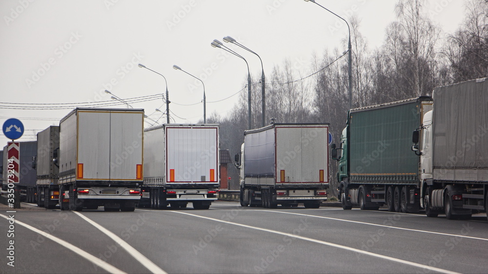Closed state border, semi trucks queue on anti viral quarantine control point at spring day, internation logistics trouble illustration concept