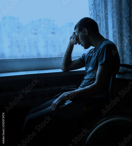 Konstfotografi Disabled person in stroller by window