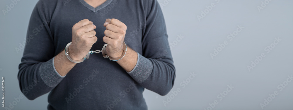 arrest; man with handcuffs on his hands