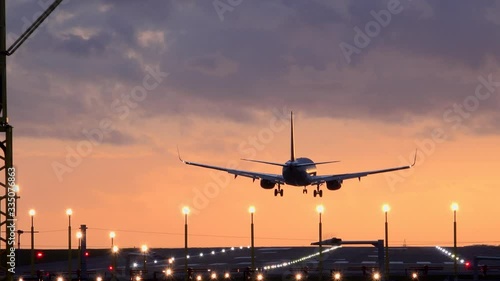 Passenger plane landing in the evening light Manchester airport UK 4K