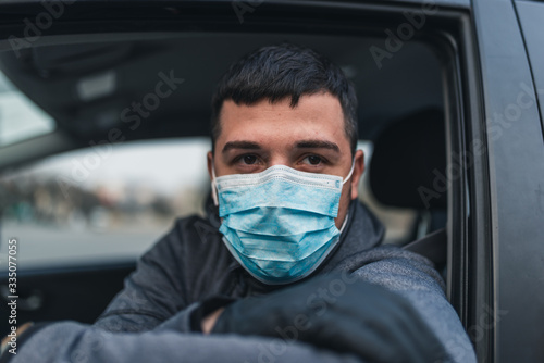 Man in the medical mask and rubber gloves for protect himself from bacteria and virus while driving a car. masked man in a car. coronavirus, disease, infection, quarantine, covid-19
