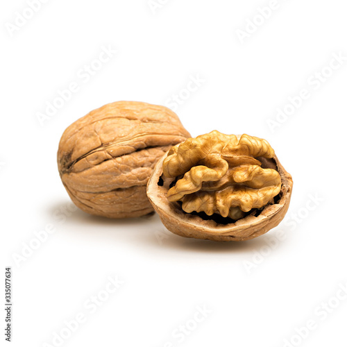 Whole and crushed walnut shell, kernel and skin closeup isolated white background