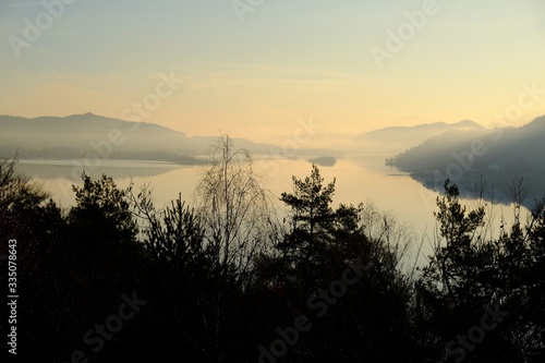 Beautiful sunrise view of the WortherSee lake from the Ferienhotel WortherSee located on the northern shores of the lake. It is the largest lake in Carinthia, Austria. photo