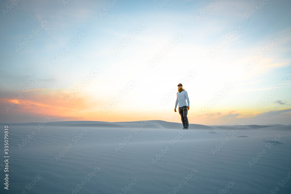 man in a white desert at sunset