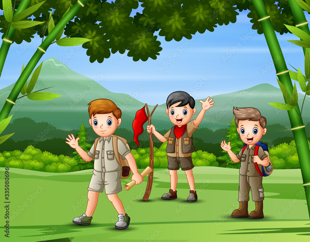 A group of scouts hiking in the forest A group of scouts hiking in the forest