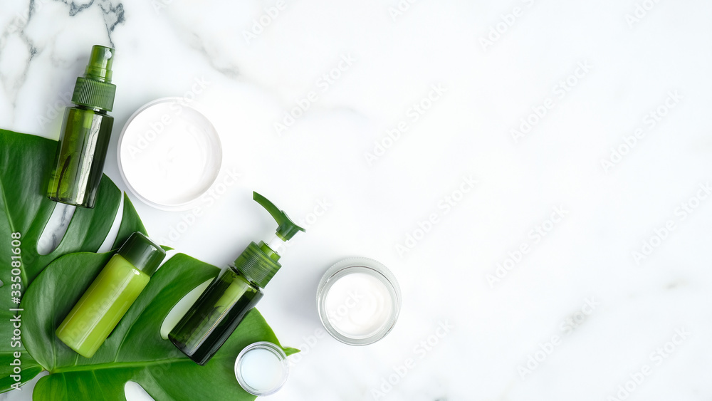 Set of natural organic cosmetics for skincare, body and hair care with tropical leaf on marble background. SPA and beauty treatment concept. Flat lay, top view, copy space Set of natural organic cosmetics for skincare, body and hair care with tropical leaf on marble background. SPA and beauty treatment concept. Flat lay, top view, copy space