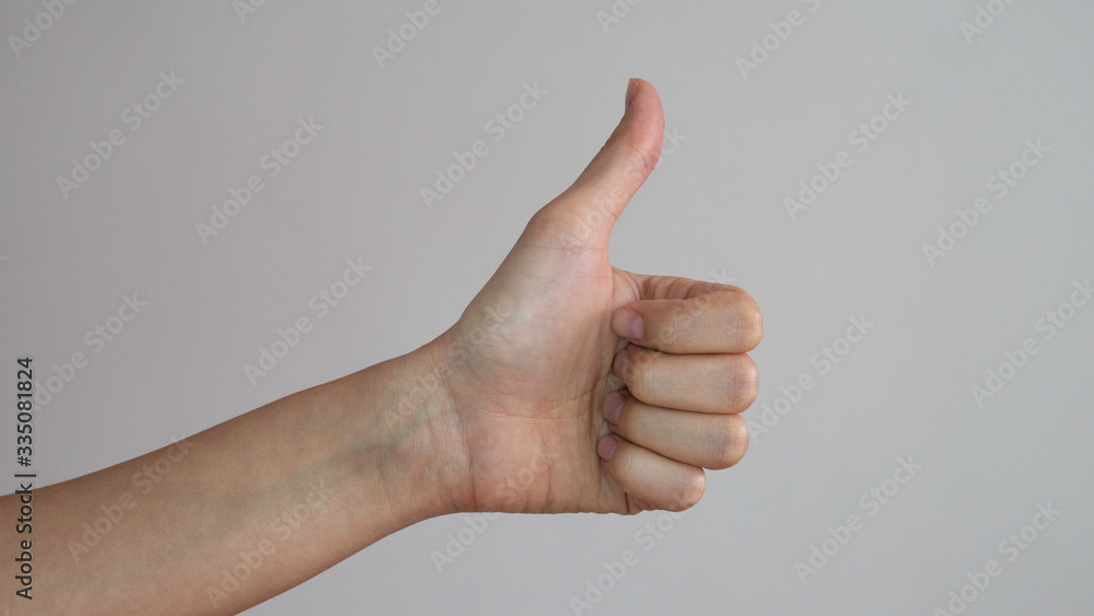 Thumb up of a left female hands on white background. Thumb up of a left female hands on white background.