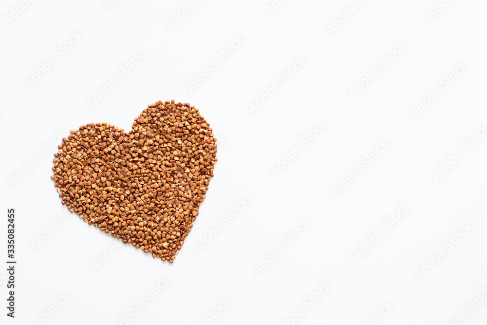 Heart from buckwheat isolated on white background. Concept of healthy food. Space for text. Heart from buckwheat isolated on white background. Concept of healthy food. Space for text.