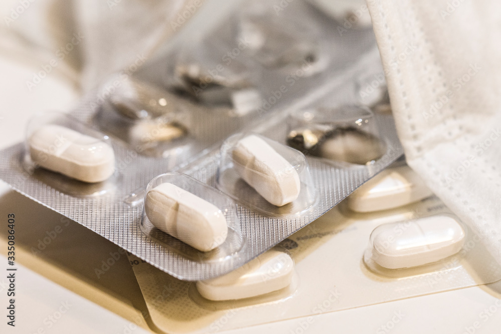 Face mask and many tablets close-up . COVID-19. Face mask and many tablets close-up . COVID-19.