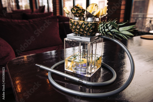 Hookah with pineapple in the smoke. Original square designer hookah photo