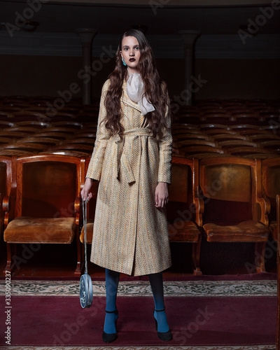 
Girl in a yellow coat at the theater