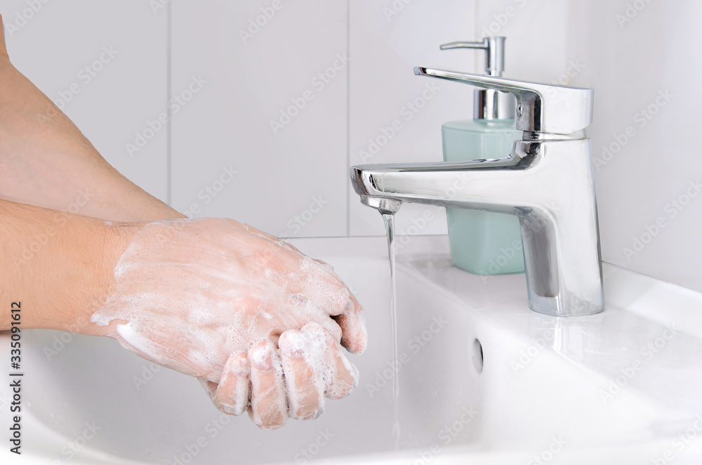 Male cleaning hands. Washing hands with soap to protect from coronavirus Male cleaning hands. Washing hands with soap to protect from coronavirus