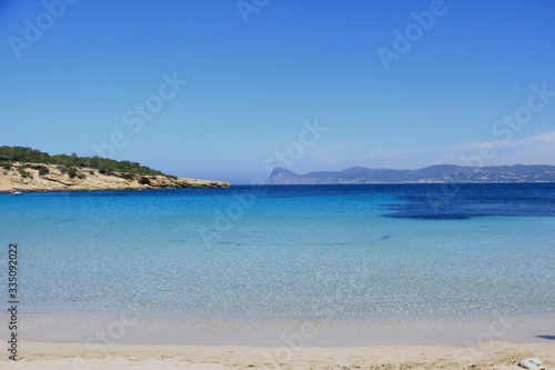 Deserted beach with turquoise waters  bright day