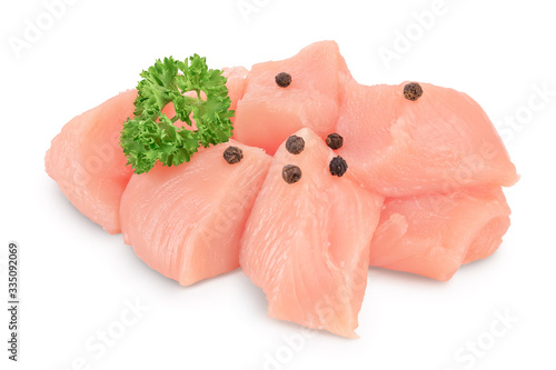 Fresh diced chicken fillet with parsley isolated on white background with clipping path and full depth of field.