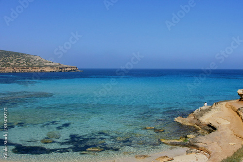 Deserted beach with turquoise waters, bright day