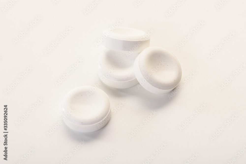 Large white round vitamin pills on a white background. Large white round vitamin pills on a white background.