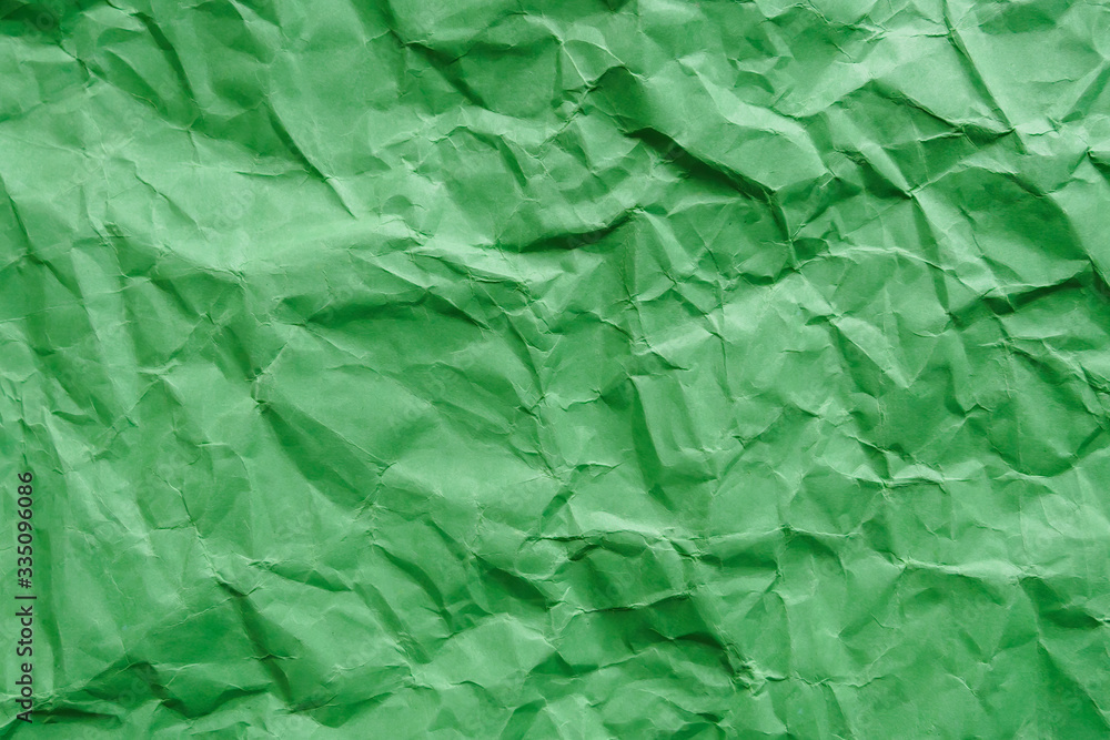 Fototapeta premium Crumpled green carton paper, blank abstract background, copy space.