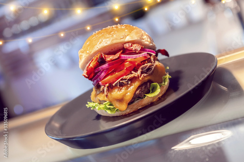 Close-up of home made tasty burgers on plate in restaurant.