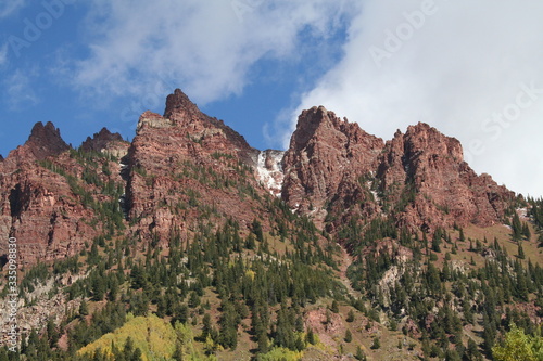 Red colored mountains with snow during autumn
