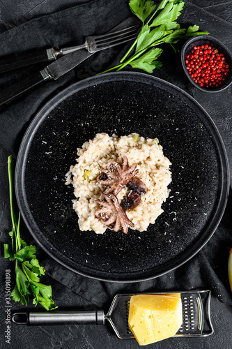 Background with homemade Risotto, octopus, mushrooms, parsley, shallots, Parmesan and spices. Top view