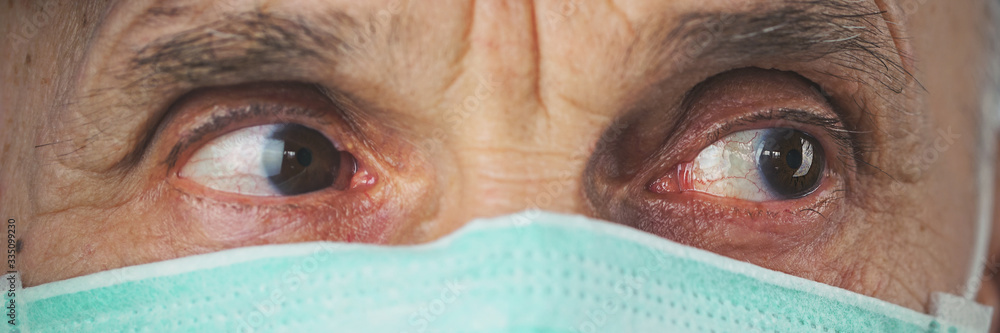 close-up head portrait of elderly man wearing in medical protective mask close-up head portrait of elderly man wearing in medical protective mask