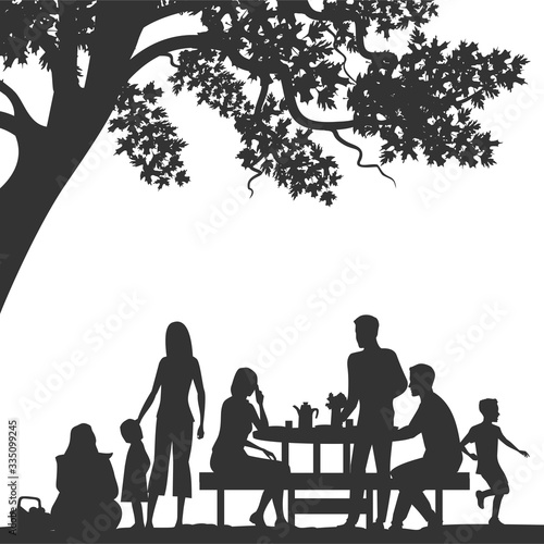 family enjoying picnic in the park. people silhouettes