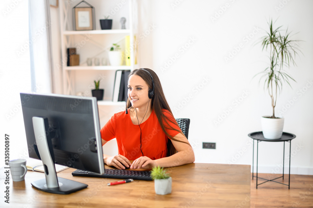 Woman using headset and pc for work Woman using headset and pc for work