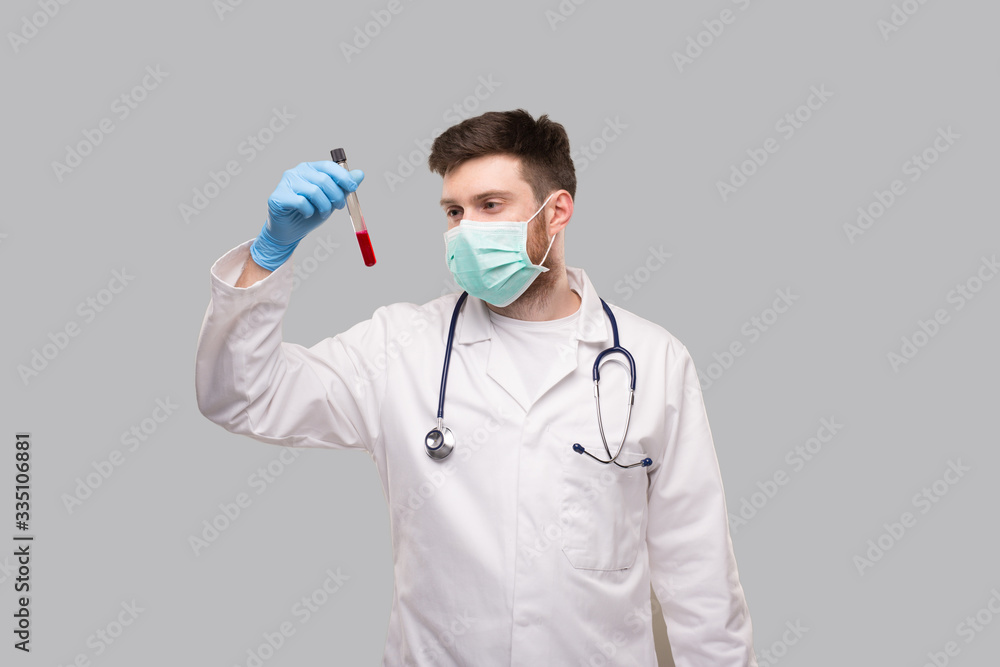 Male Doctor Checking Blood Analysis Wearing Medical Mask and Gloves. Doctor Isolated Male Doctor Checking Blood Analysis Wearing Medical Mask and Gloves. Doctor Isolated