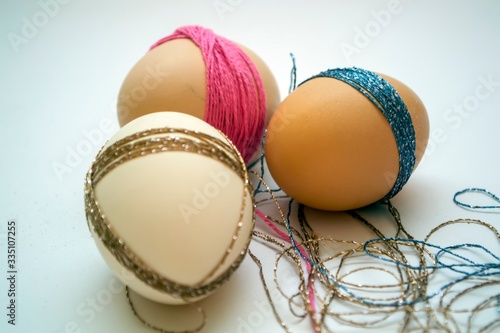 Three coiled eggs with thread close-up