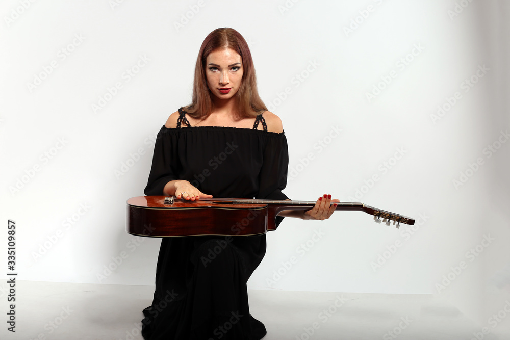 Pretty woman with a guitar on white background Pretty woman with a guitar on white background