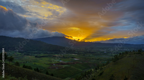 Vibrant vivid golden sunset over Karo batak highlands hills near to lake Toba or Medan