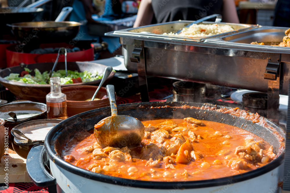 Cheff cooking delicious chicken soup dish outdoor. Cheff cooking delicious chicken soup dish outdoor.