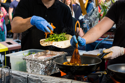 Canvas Print Cheff preparing tasty vegetarian kebab dish on food stand.