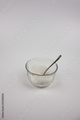 Sugar in a small cup on a white background 