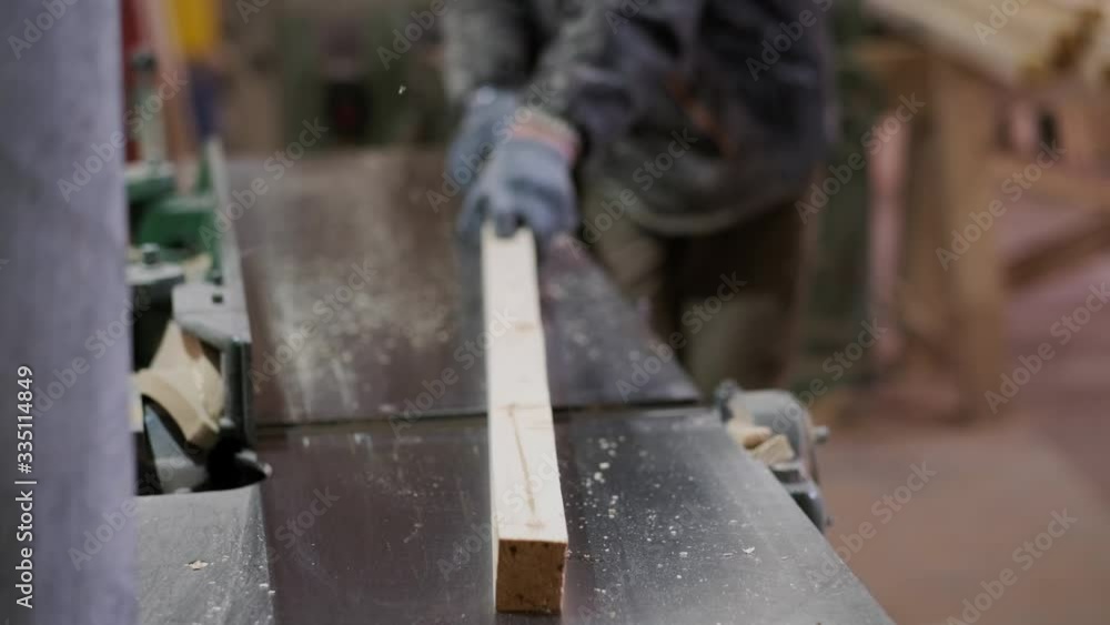 The joiner works on a woodworking machine. Work in a carpentry workshop. Production of furniture. The joiner works on a woodworking machine. Work in a carpentry workshop. Production of furniture.