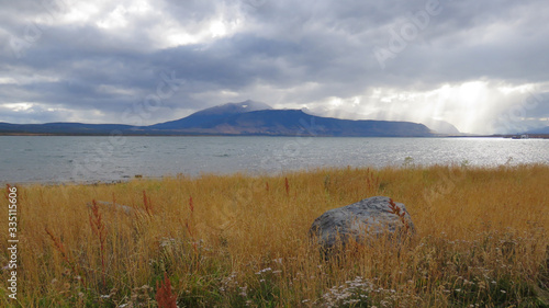 Puerto Natales, Patagonia, Chile: Ultima Esperanza (Last Hope) fjord and grass field photo