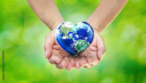  Earth Heart in Hands on Green Blurred Nature background, World Environment Day and Give Love to Our World Concept, Elements of this image furnished by NASA